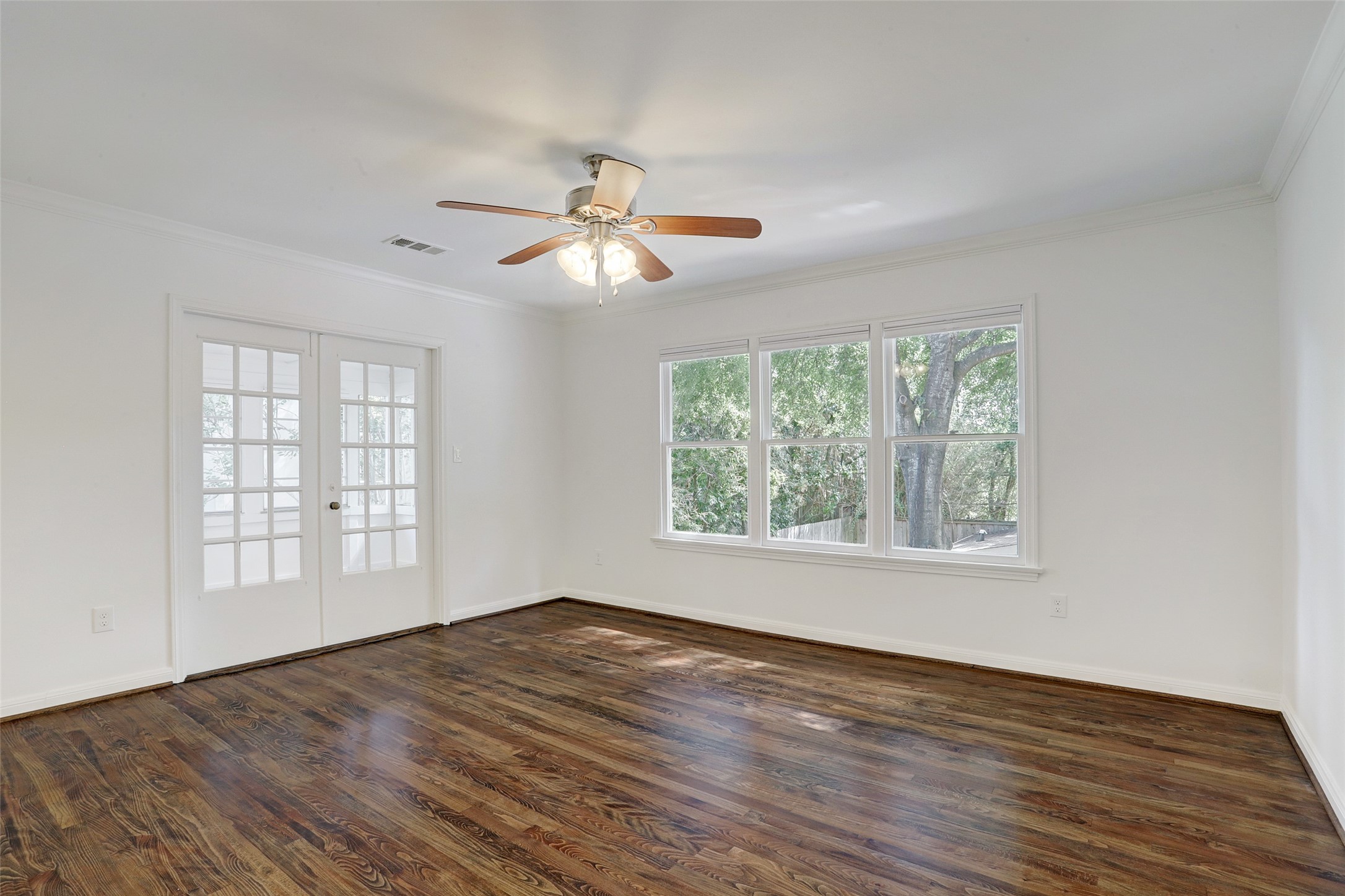 2011 South Boulevard Houston, TX 77098 - Photo 14 of 24 a view of empty room with wooden floor and fan