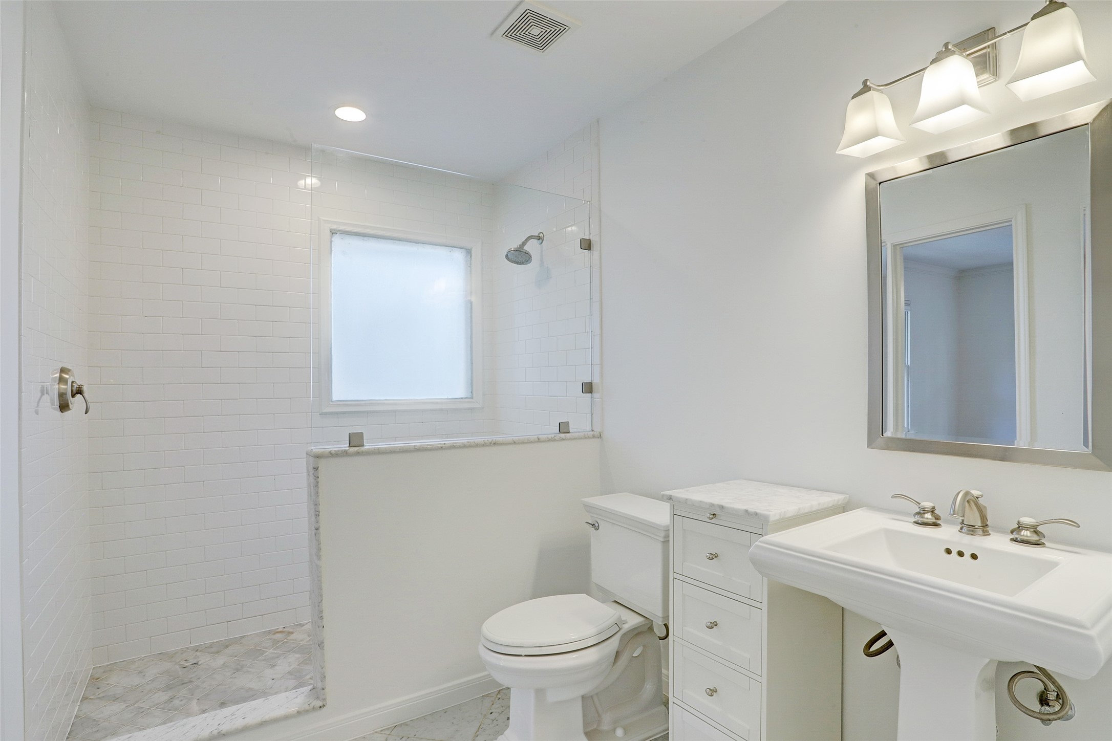 2011 South Boulevard Houston, TX 77098 - Photo 20 of 24 a bathroom with a toilet a sink and mirror