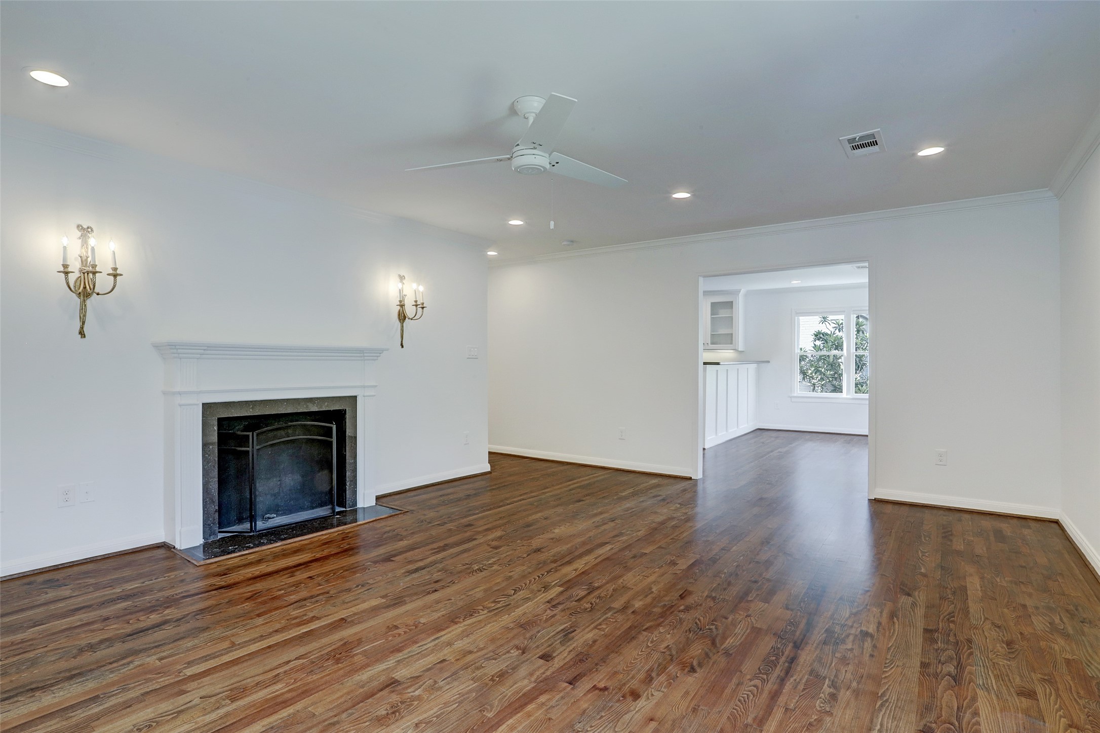 2011 South Boulevard Houston, TX 77098 - Photo 2 of 24 an empty room with wooden floor fireplace and windows