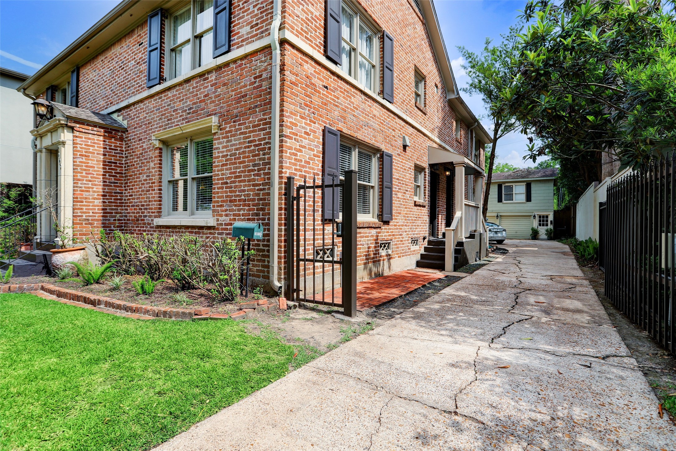2011 South Boulevard Houston, TX 77098 - Photo 22 of 24 a view of a house with many windows and plants