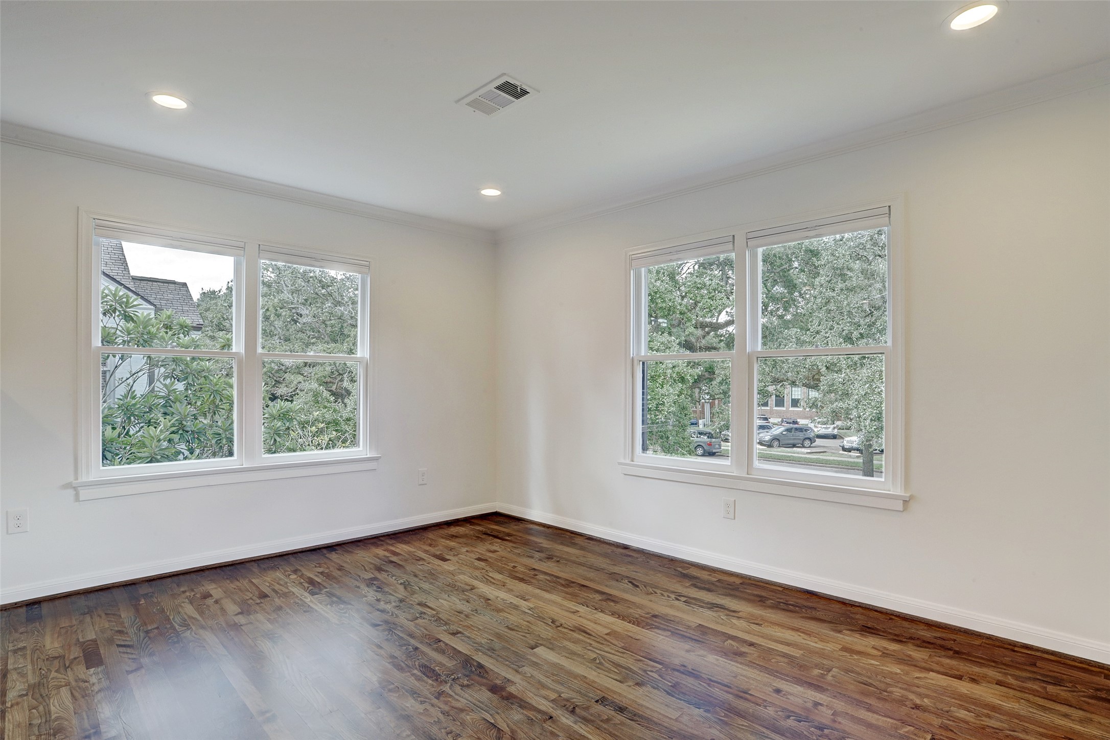 2011 South Boulevard Houston, TX 77098 - Photo 5 of 24 a view of an empty room with wooden floor and a window