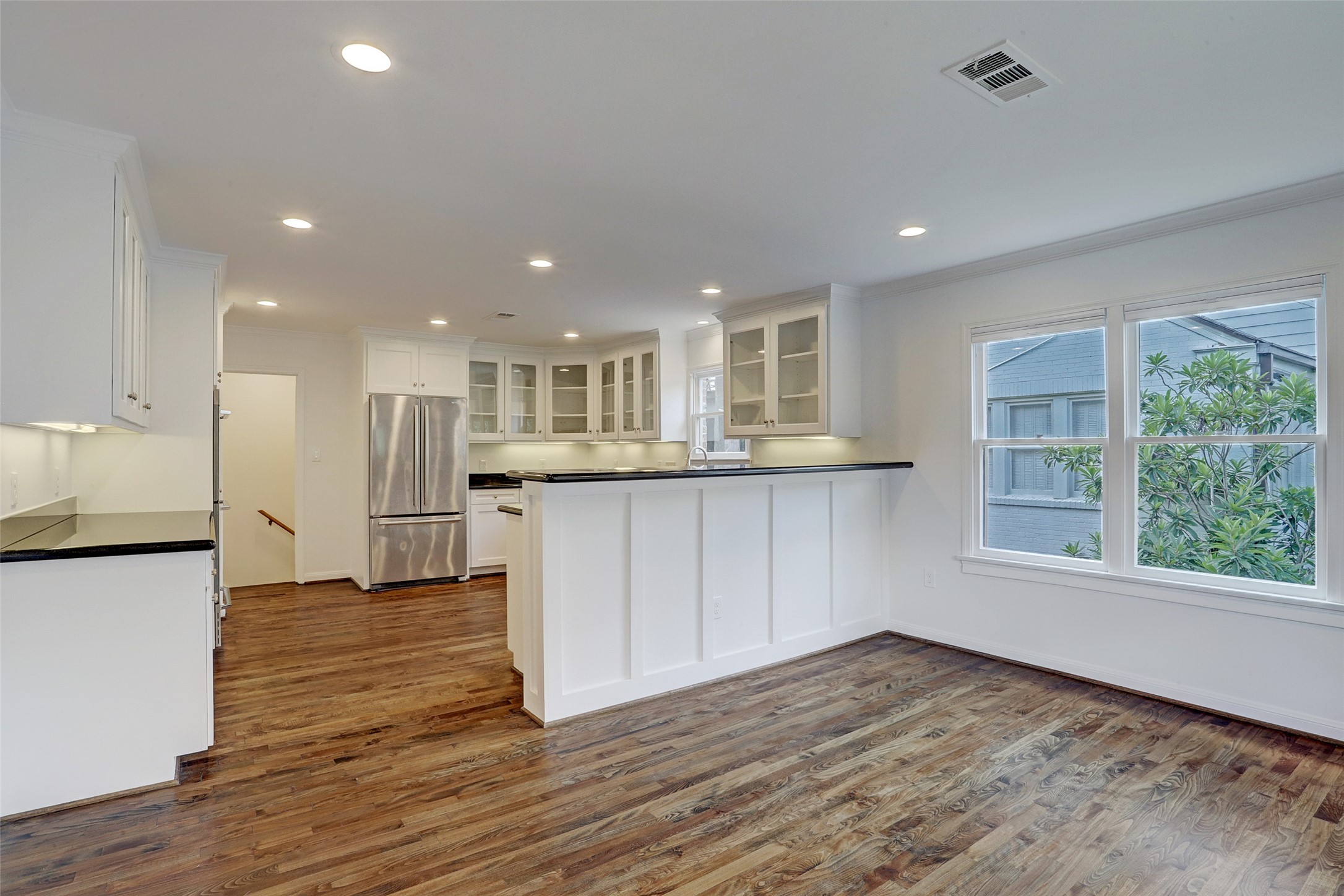 2011 South Boulevard Houston, TX 77098 - Photo 6 of 24 a view of kitchen with wooden floor and electronic appliances