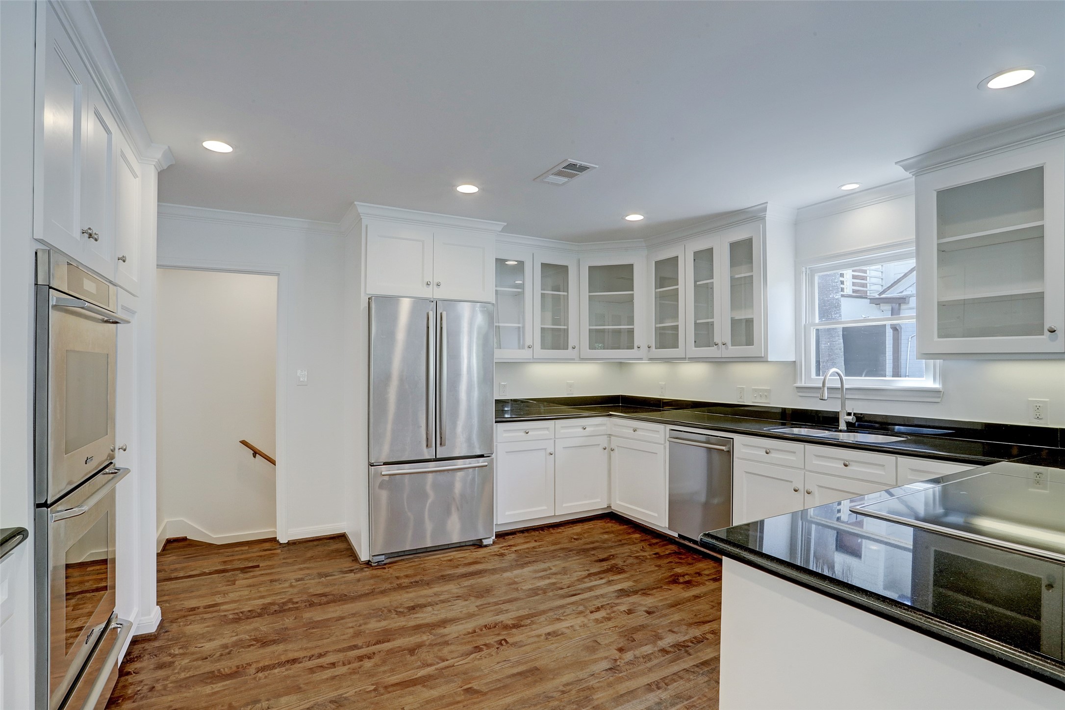 2011 South Boulevard Houston, TX 77098 - Photo 7 of 24 a kitchen with stainless steel appliances granite countertop a refrigerator and a sink