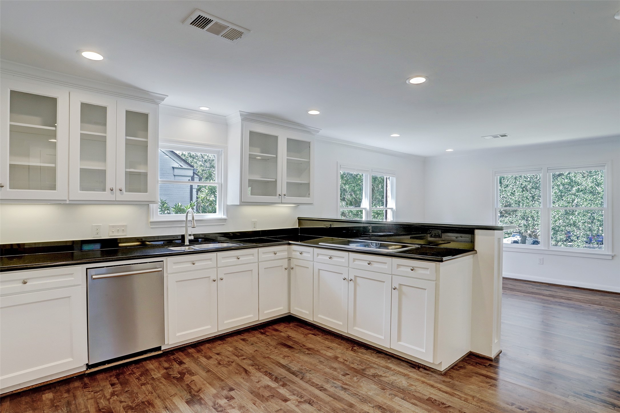 2011 South Boulevard Houston, TX 77098 - Photo 9 of 24 a kitchen with granite countertop a sink and white cabinets