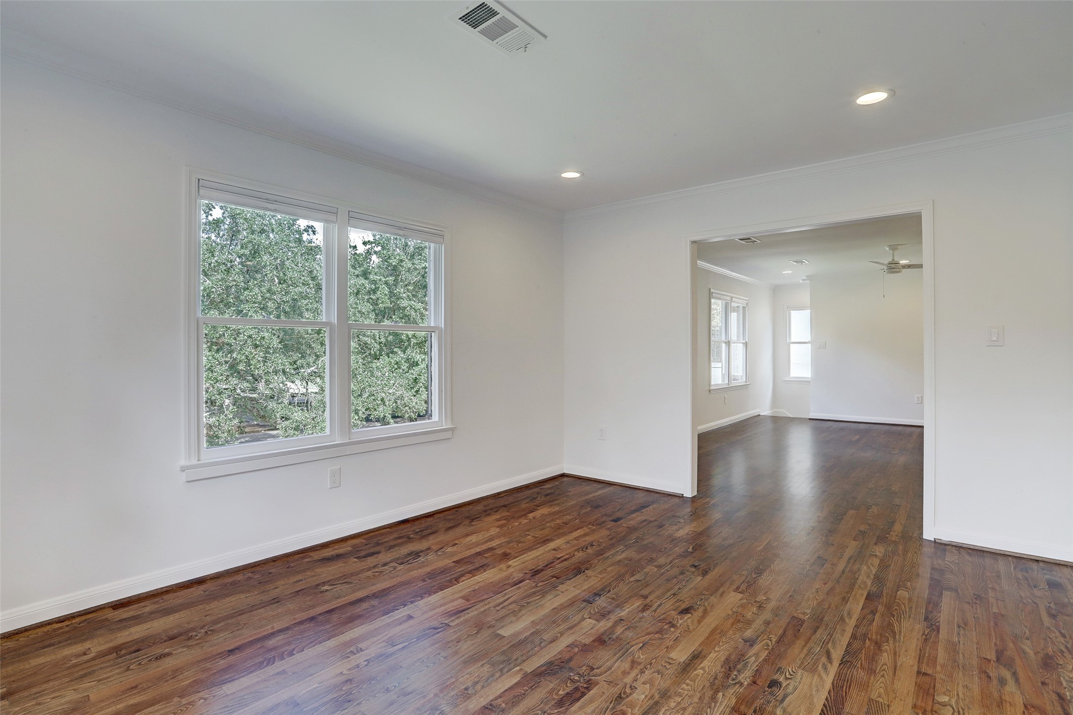 2011 South Boulevard Houston, TX 77098 - Photo 10 of 24 an empty room with wooden floor and windows