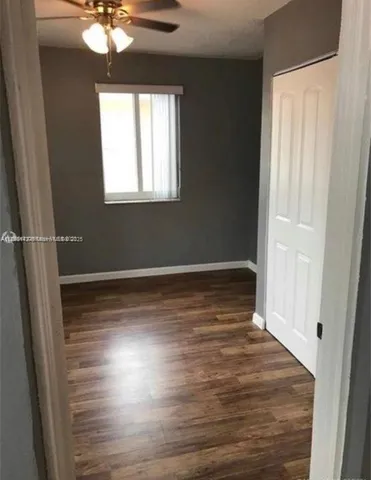 a view of wooden floor and windows in a room