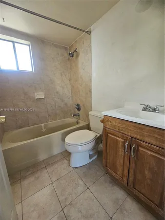 a bathroom with a toilet a sink and bathtub