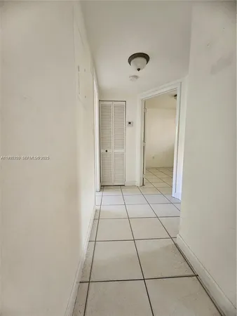 a view of a livingroom with an empty space and a window