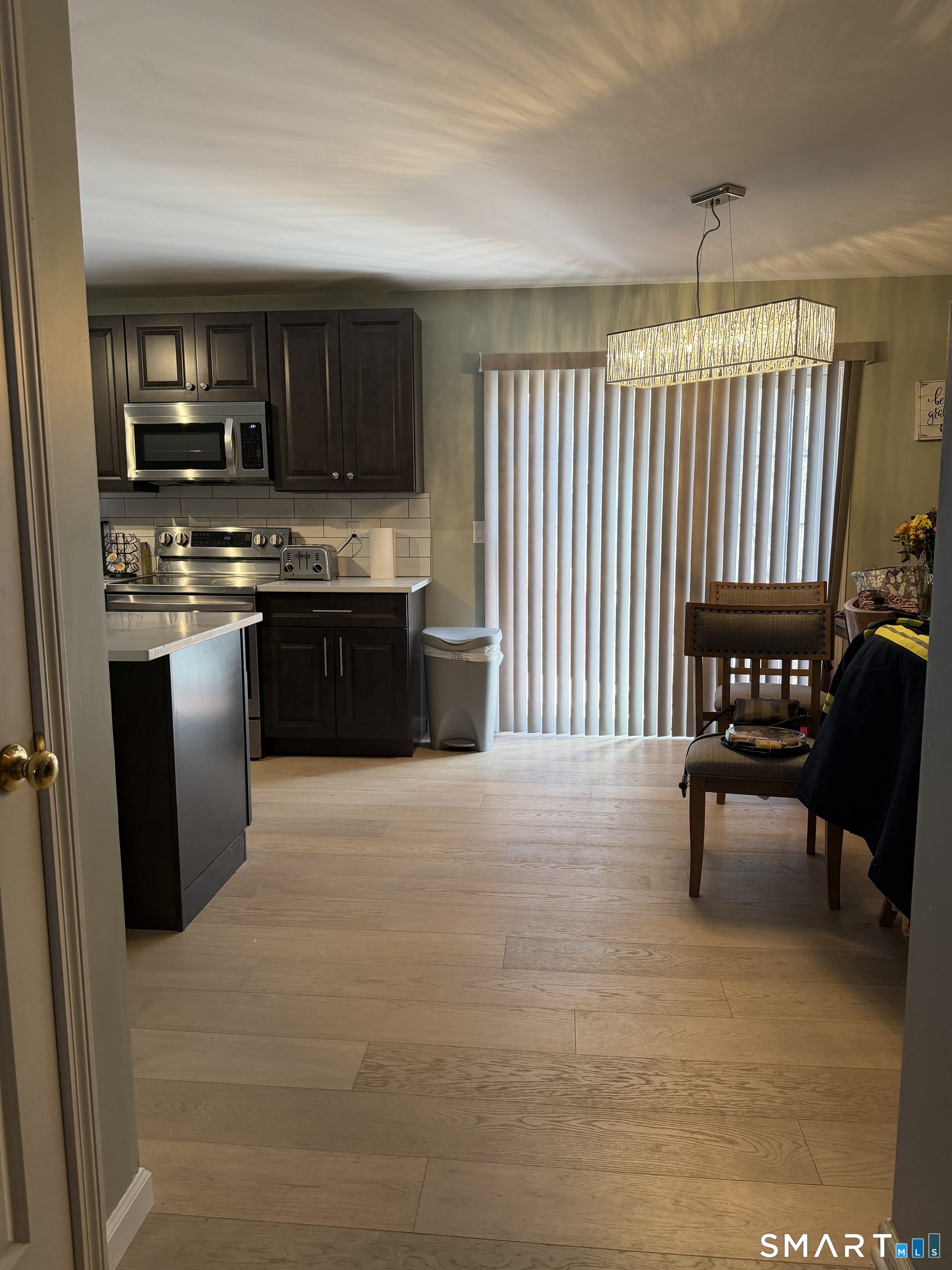 61 Victoria Court Hamden, CT 06514 - Photo 4 of 10 a kitchen with stainless steel appliances granite countertop a stove a sink and a microwave