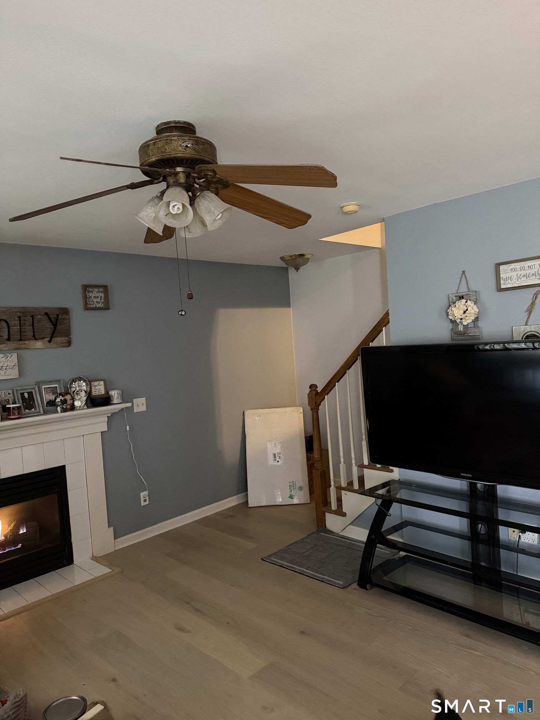 61 Victoria Court Hamden, CT 06514 - Photo 6 of 10 a room with gym equipment and a fireplace