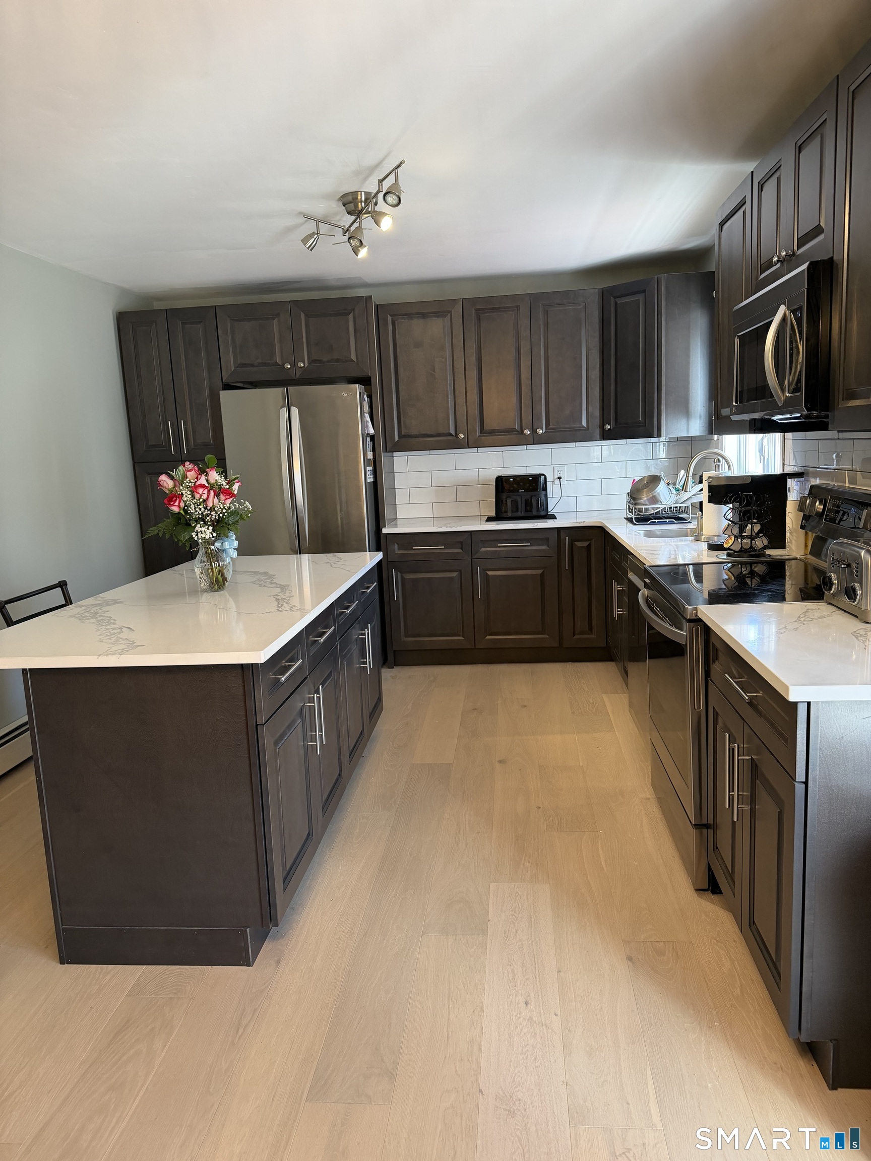 61 Victoria Court Hamden, CT 06514 - Photo 9 of 10 a kitchen with stainless steel appliances a sink dishwasher stove and microwave