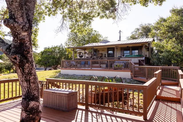 a view of a balcony with chairs and wooden floor