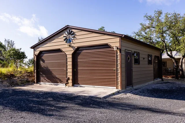 a view of a house with a tree in the yard
