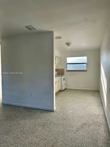 a view of a room with closet and windows