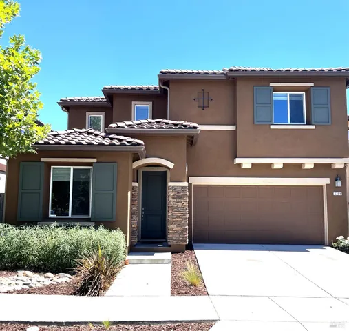 a front view of a house with yard