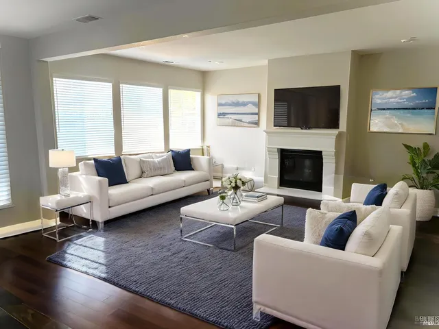 a living room with furniture flat screen tv and a fireplace