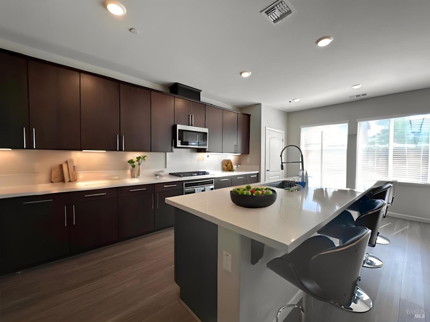 5204 Kim Place Rohnert Park, CA 94928 - Photo 5 of 13 a kitchen with a stove a sink a microwave a dining table and chairs