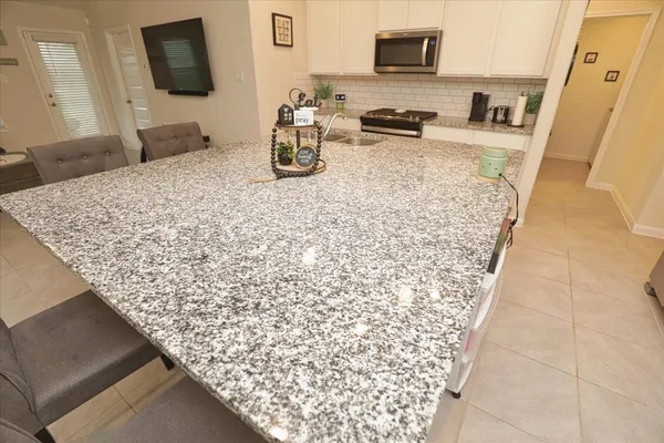 a kitchen with a sink and a stove top oven
