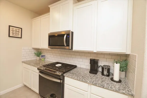 a kitchen with a stove and a microwave