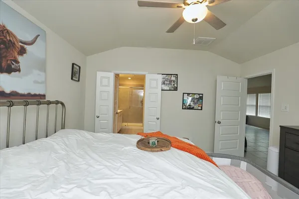 a bedroom with a bed and a flat screen tv