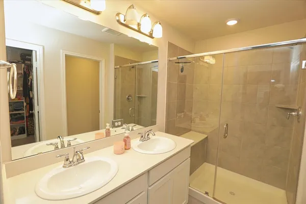 a white toilet sitting next to a white wall