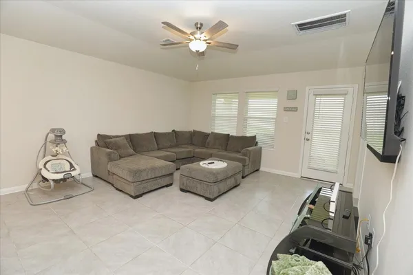 a living room with furniture and a chandelier