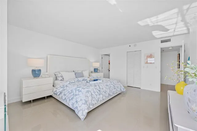 a bedroom with a bed couch and a couch