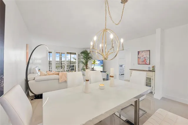 a very nice looking dining room with a table and chandelier
