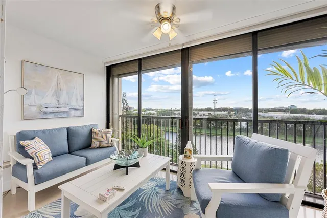 a living room with furniture and a floor to ceiling window