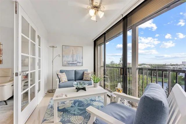 a living room with furniture and a floor to ceiling window