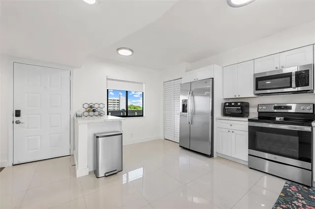 a kitchen with stainless steel appliances a refrigerator stove and microwave