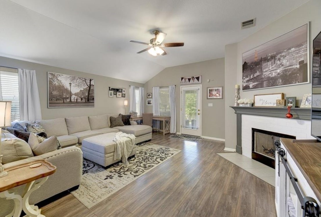a living room with furniture and a fireplace