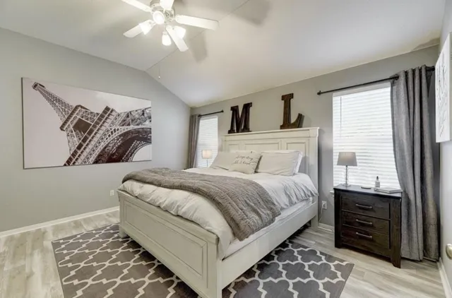 a bedroom with a large bed and a window