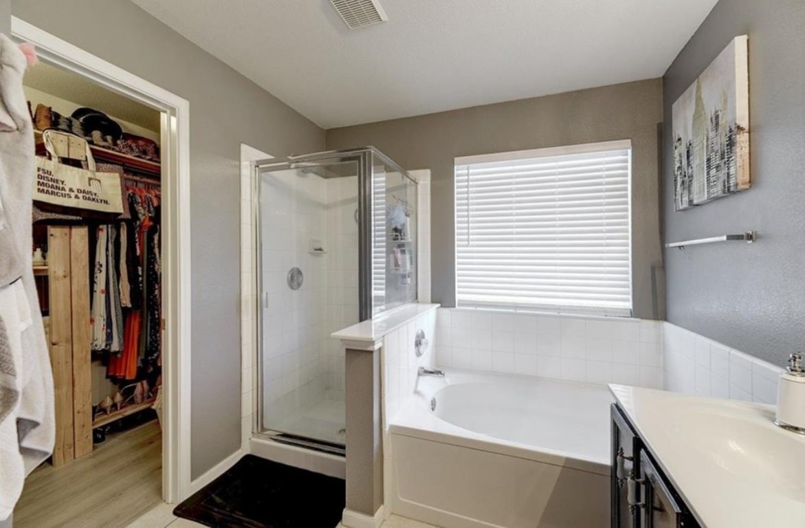 1307 Ridgewood Drive Leander, TX 78641 - Photo 12 of 16 a bathroom with a bathtub and a sink