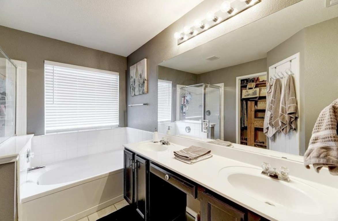 1307 Ridgewood Drive Leander, TX 78641 - Photo 13 of 16 a bathroom with a tub sink and mirror