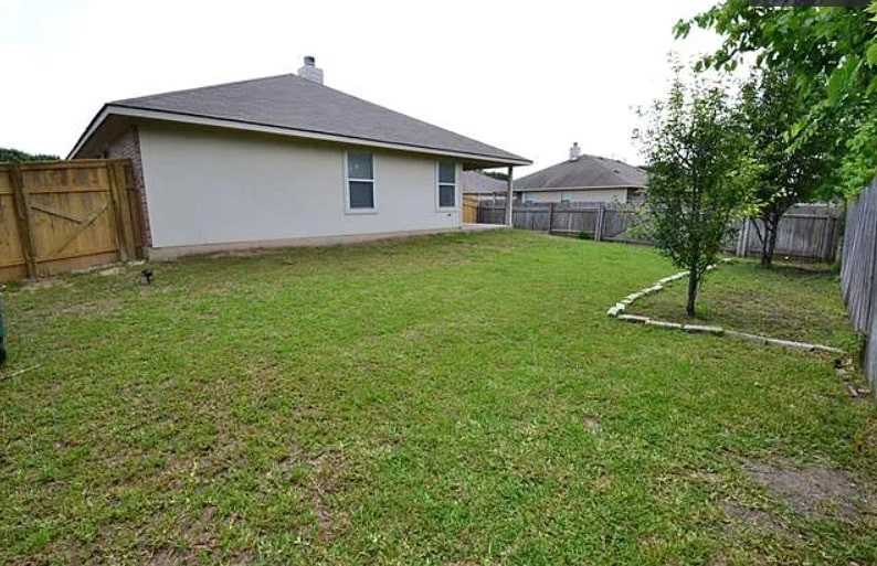 1307 Ridgewood Drive Leander, TX 78641 - Photo 16 of 16 a white house that has a sign on it and garden