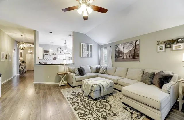 a living room with furniture and wooden floor