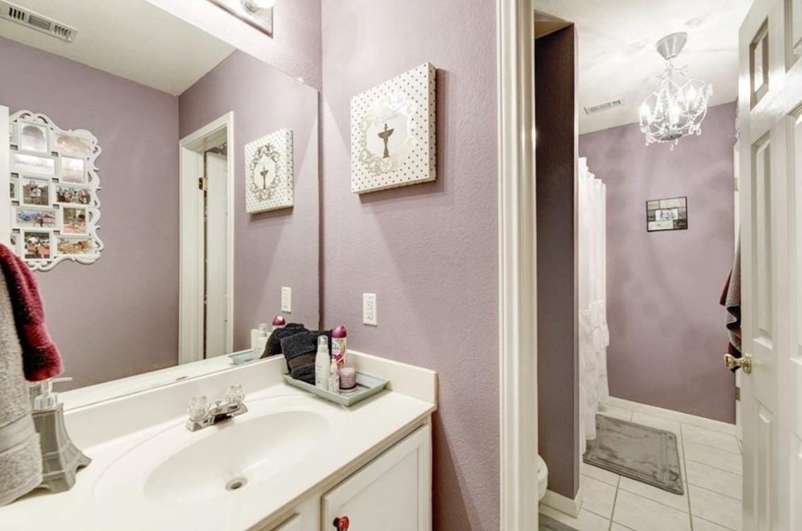 1307 Ridgewood Drive Leander, TX 78641 - Photo 4 of 16 a bathroom with a sink vanity and a mirror