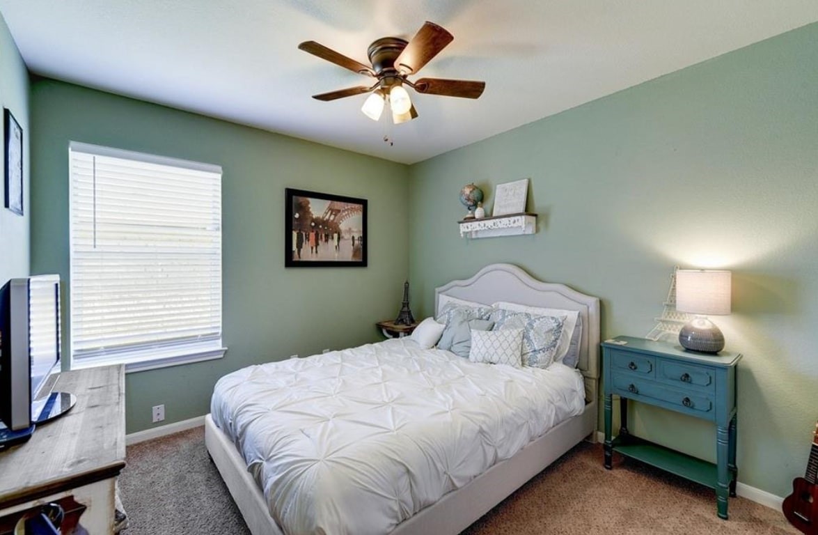 1307 Ridgewood Drive Leander, TX 78641 - Photo 9 of 16 a bedroom with a bed and a window