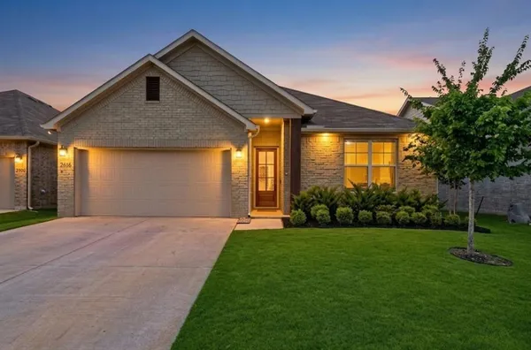 a front view of house with yard and green space