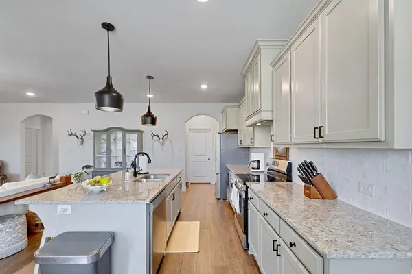 a kitchen that has a lot of cabinets in it