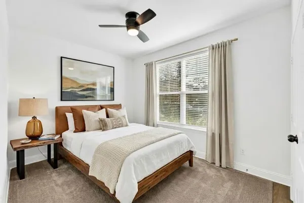 a bedroom with a bed and window