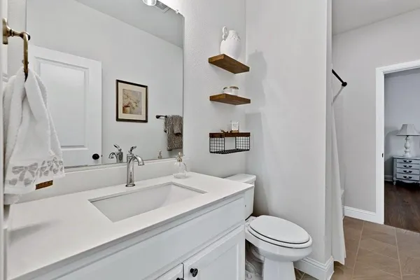a bathroom with a sink toilet and vanity