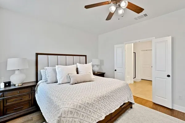 a bedroom with a bed and a night stand