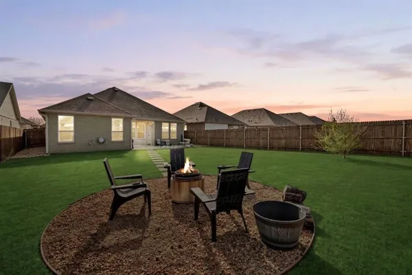 a view of a house with backyard sitting area and garden