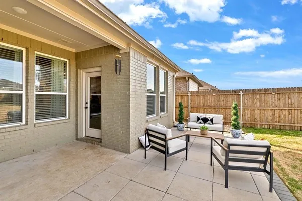 a building outdoor space with patio furniture and potted plants