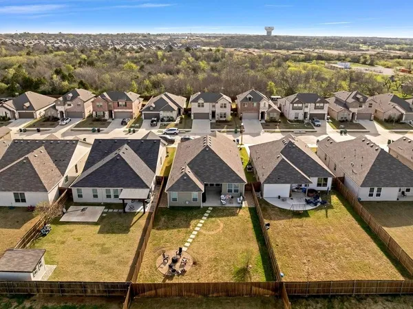 an aerial view of residential houses with outdoor space