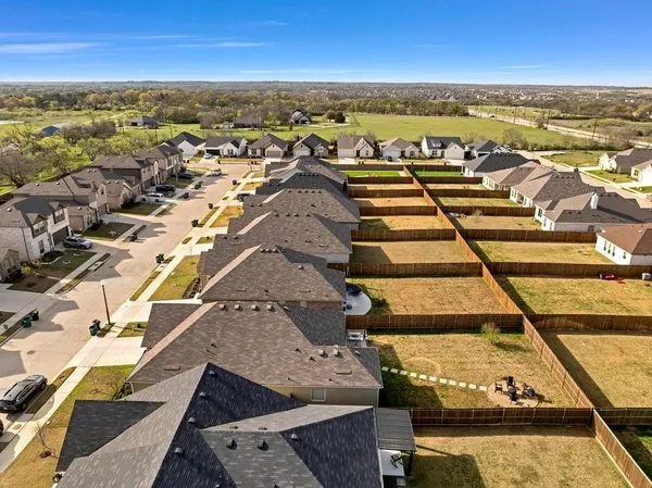 an aerial view of residential houses with outdoor space