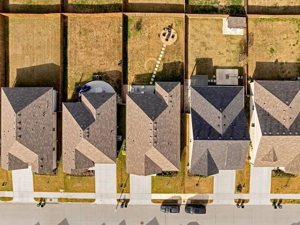 an aerial view of houses with outdoor space
