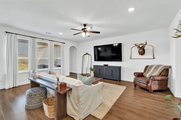 a living room with furniture and a flat screen tv